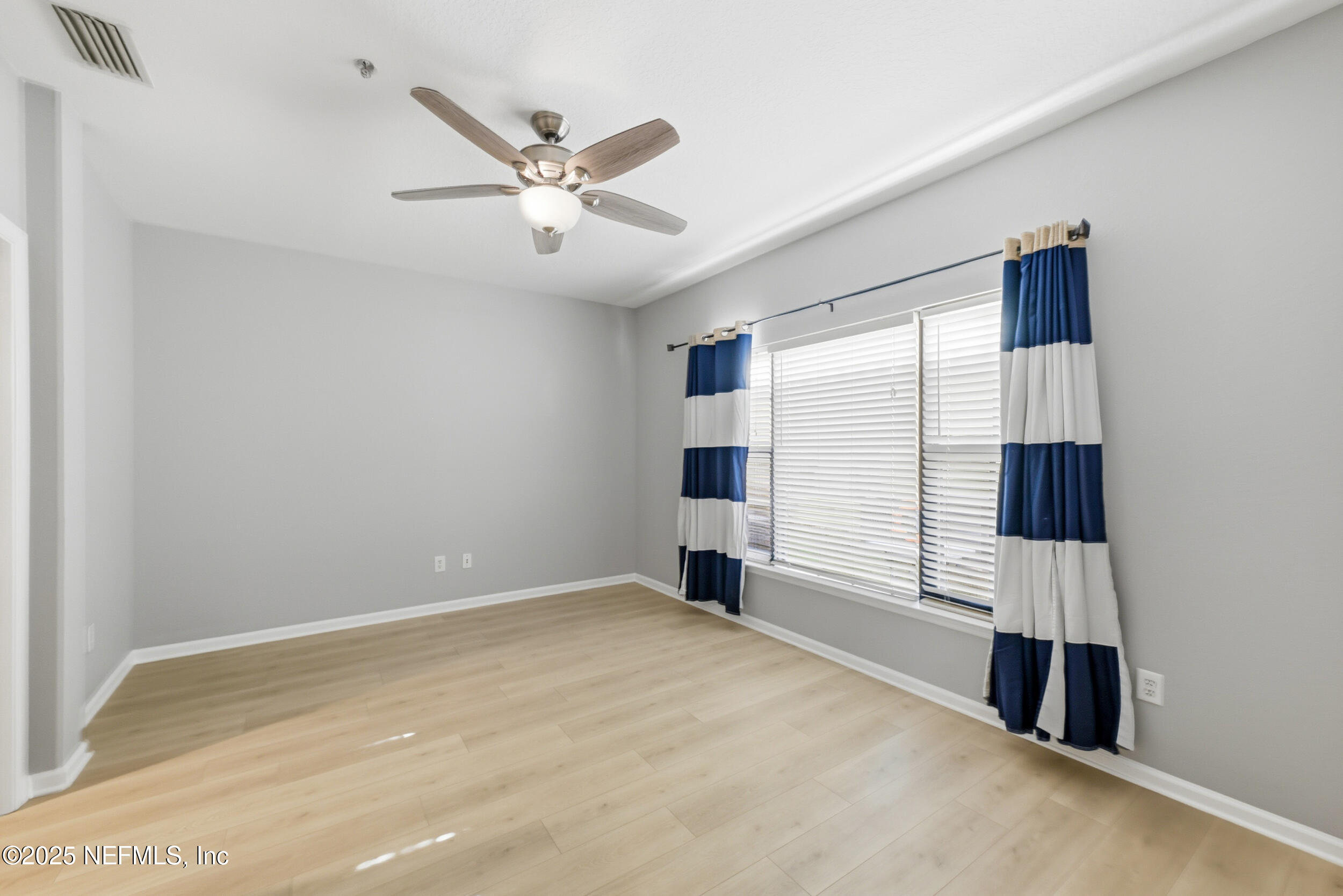 415 La Travesia Flora, Unit 102 St. Augustine, FL 32095 - Photo 5 of 11 a view of a livingroom with a ceiling fan