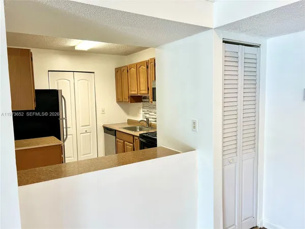 a kitchen with stainless steel appliances a refrigerator and a stove top oven