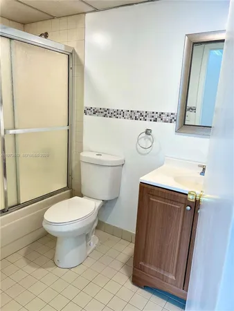 a bathroom with a toilet a sink and a shower