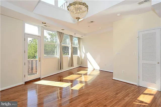 a view of an empty room with glass door