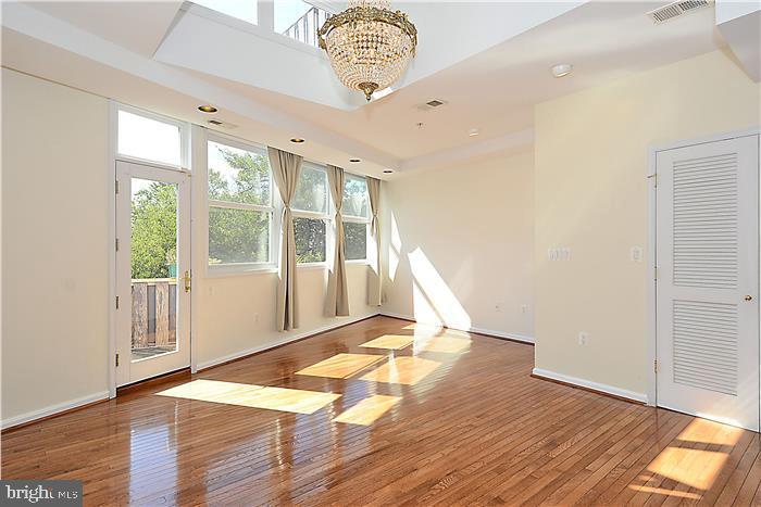 a view of an empty room with glass door