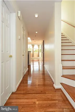 a view of a hallway with wooden floor