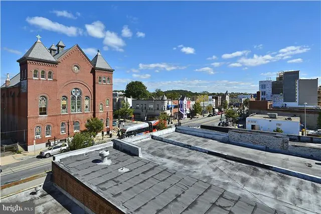 a view of a building with cars parked