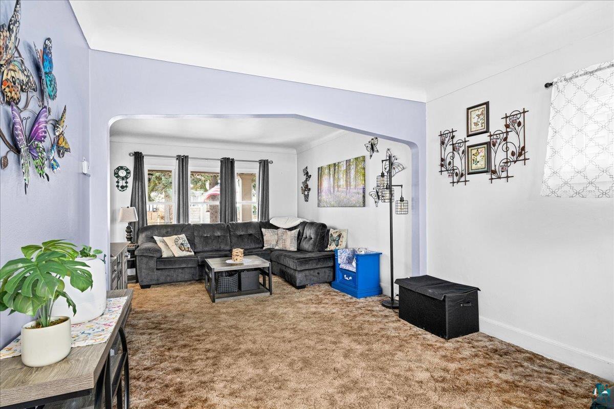 4316 West 6th Street Duluth, MN 55807 - Photo 22 of 39 Carpeted living area with arched walkways and baseboards