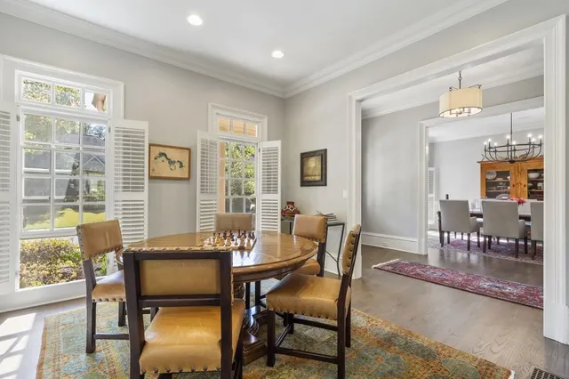 a living room with furniture a flat screen tv and kitchen view