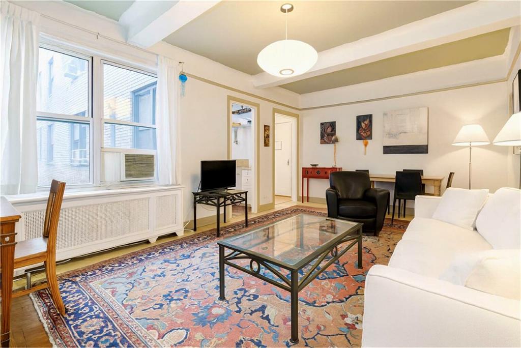 70 Remsen Street, Unit 4F Brooklyn, NY 11201 - Photo 3 of 11 a living room with furniture a flat screen tv and a table