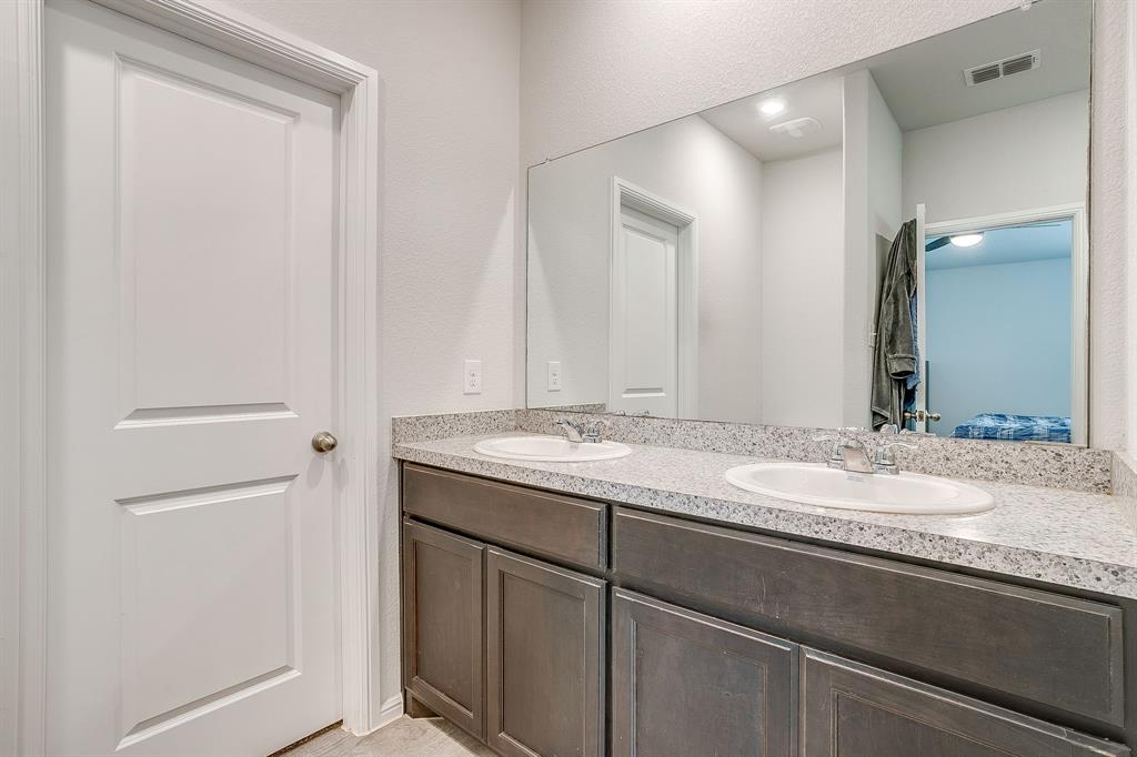2313 Stallings Road Fort Worth, TX 76108 - Photo 18 of 30 a bathroom with a granite countertop sink and a mirror