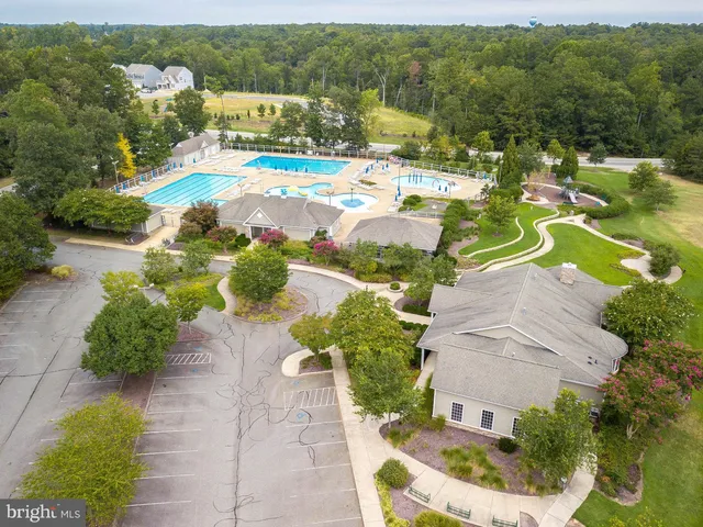 an aerial view of residential houses with outdoor space and swimming pool