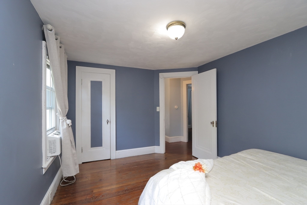 34 Preston Street Springfield, MA 01109 - Photo 16 of 34 a bedroom with a bed and wooden floor