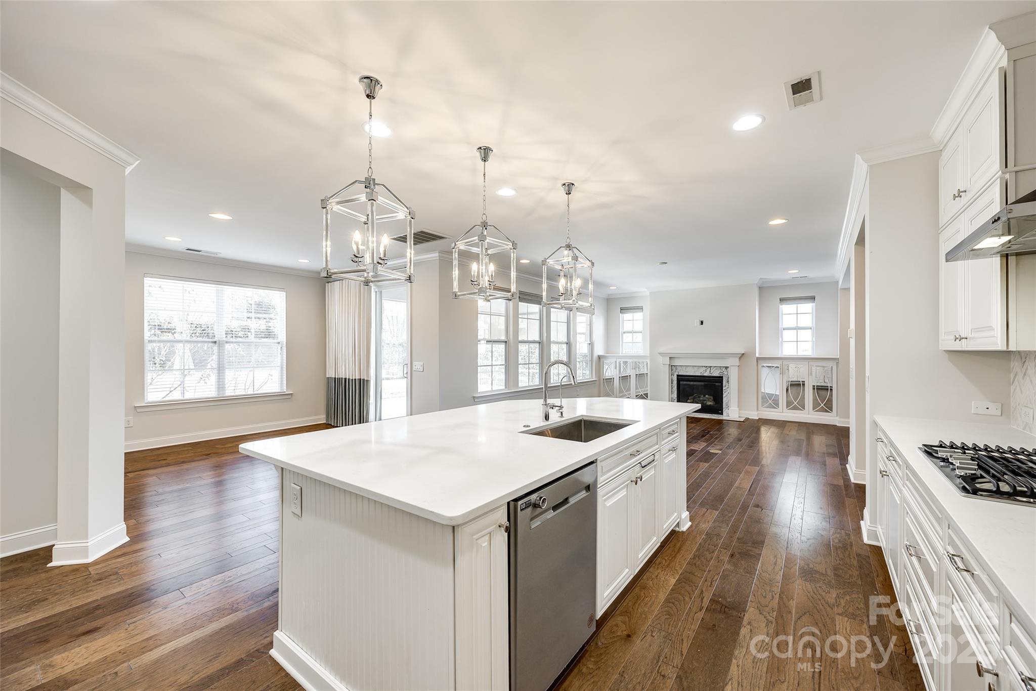 1056 Emory Lane Fort Mill, SC 29708 - Photo 12 of 48 a large kitchen with kitchen island a stove a sink a center island and wooden floor