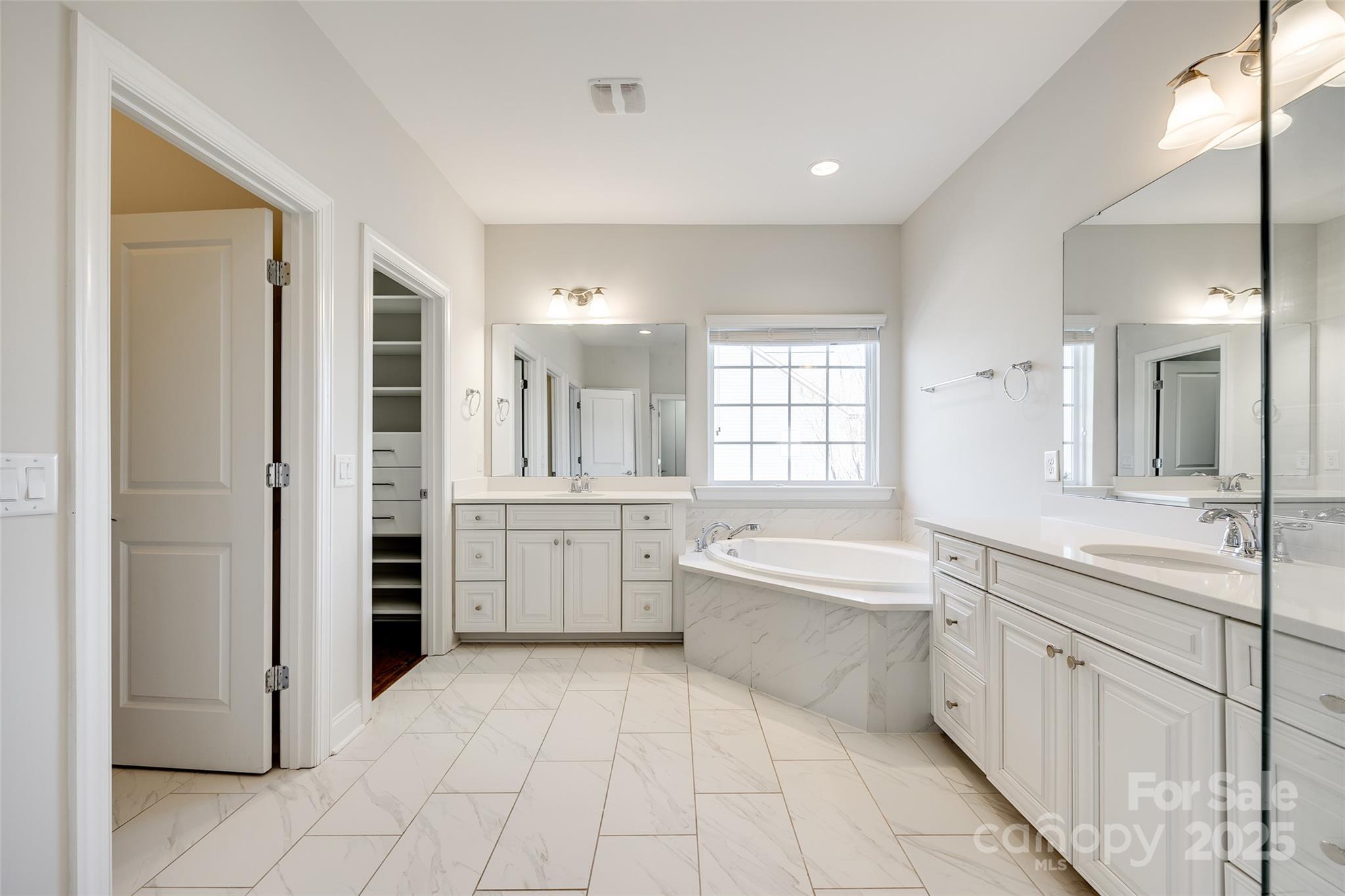 1056 Emory Lane Fort Mill, SC 29708 - Photo 22 of 48 a large bathroom with a large mirror vanity shower and bathtub