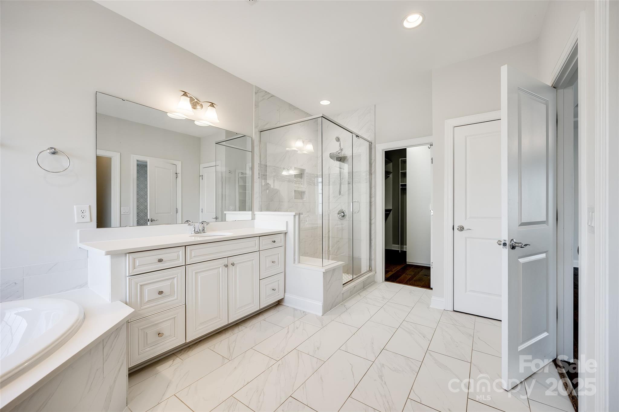 1056 Emory Lane Fort Mill, SC 29708 - Photo 23 of 48 a spacious bathroom with a granite countertop sink mirror and shower