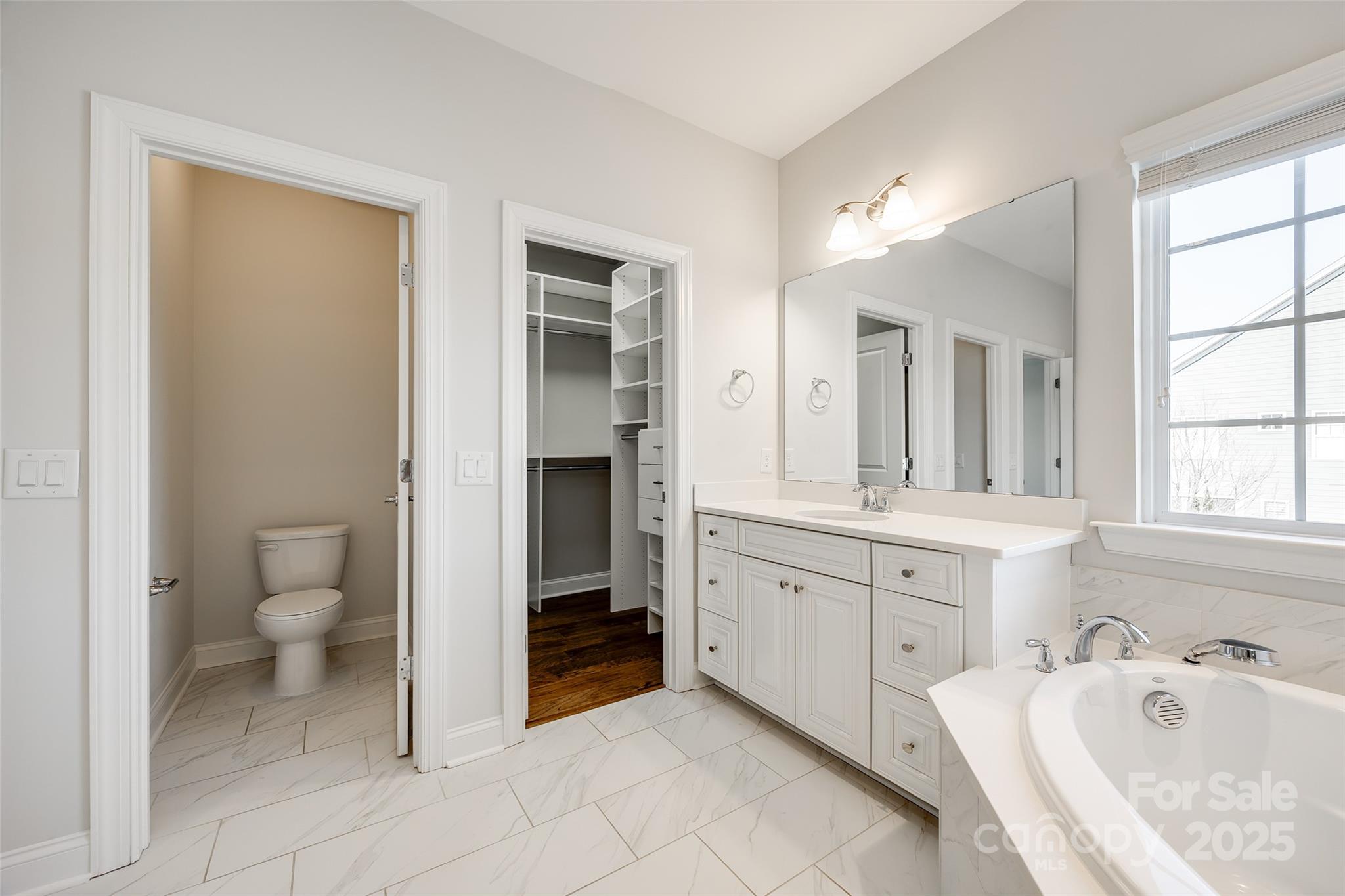 1056 Emory Lane Fort Mill, SC 29708 - Photo 24 of 48 a spacious bathroom with a granite countertop sink and a mirror