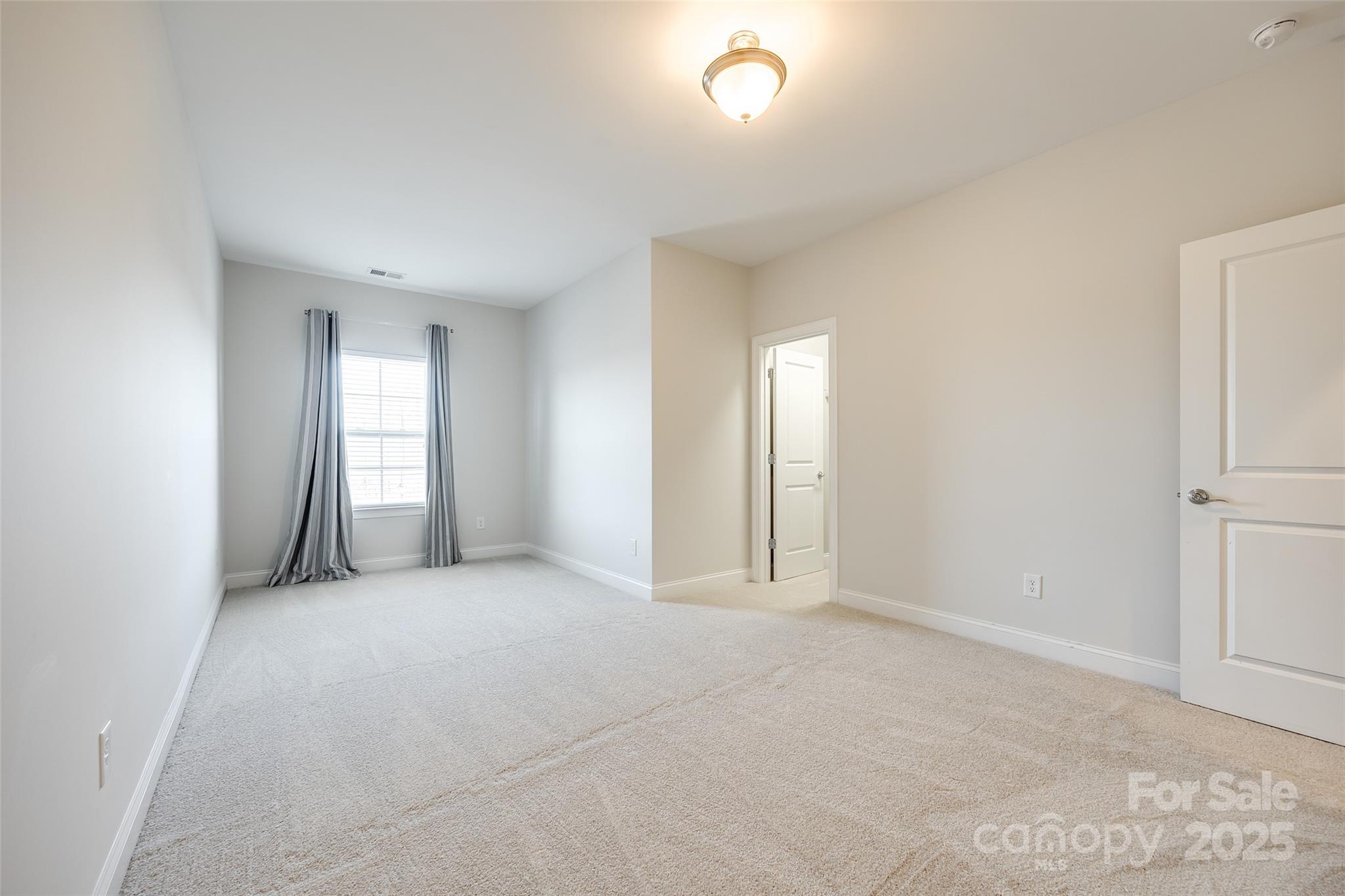 1056 Emory Lane Fort Mill, SC 29708 - Photo 28 of 48 an empty room with windows and closet
