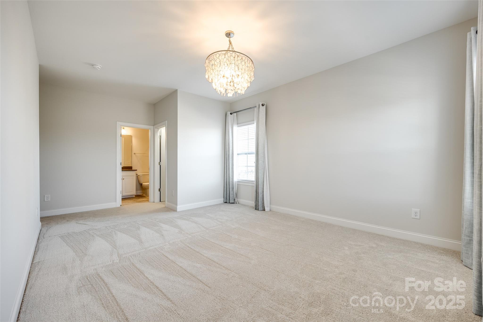 1056 Emory Lane Fort Mill, SC 29708 - Photo 32 of 48 an empty room with chandelier fan and windows