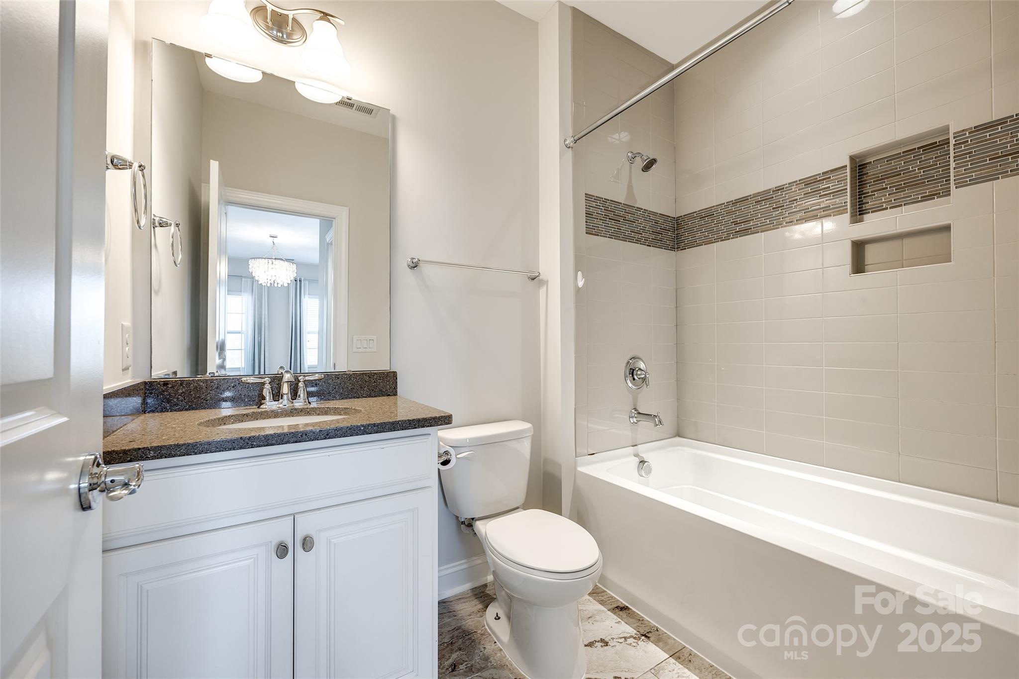 1056 Emory Lane Fort Mill, SC 29708 - Photo 33 of 48 a bathroom with a granite countertop sink a toilet a mirror and shower