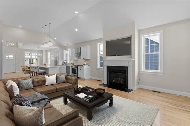 a living room with furniture fireplace and flat screen tv