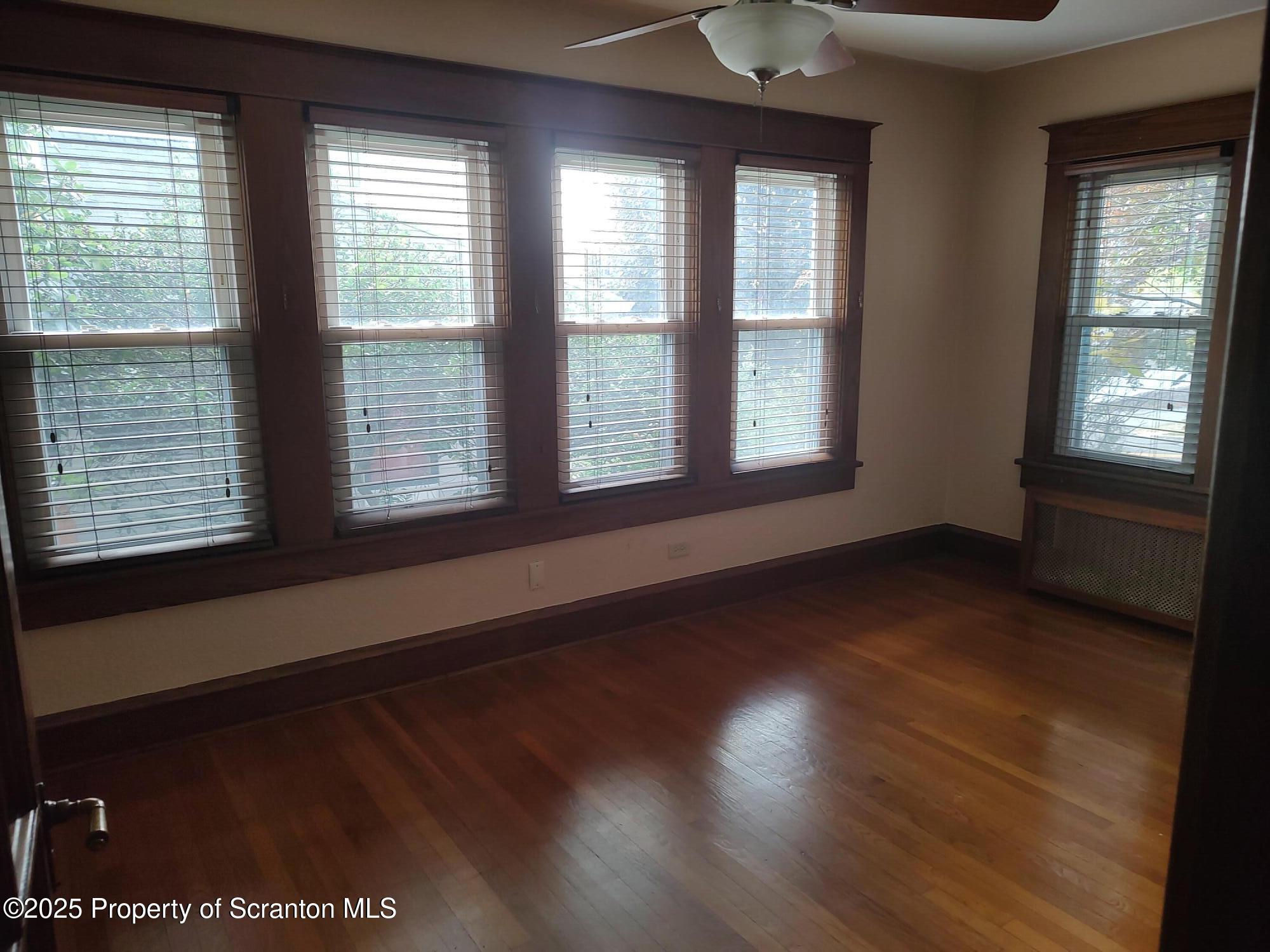 215 West Grove Street Clarks Summit, PA 18411 - Photo 12 of 26 a view of an empty room with wooden floor and a window