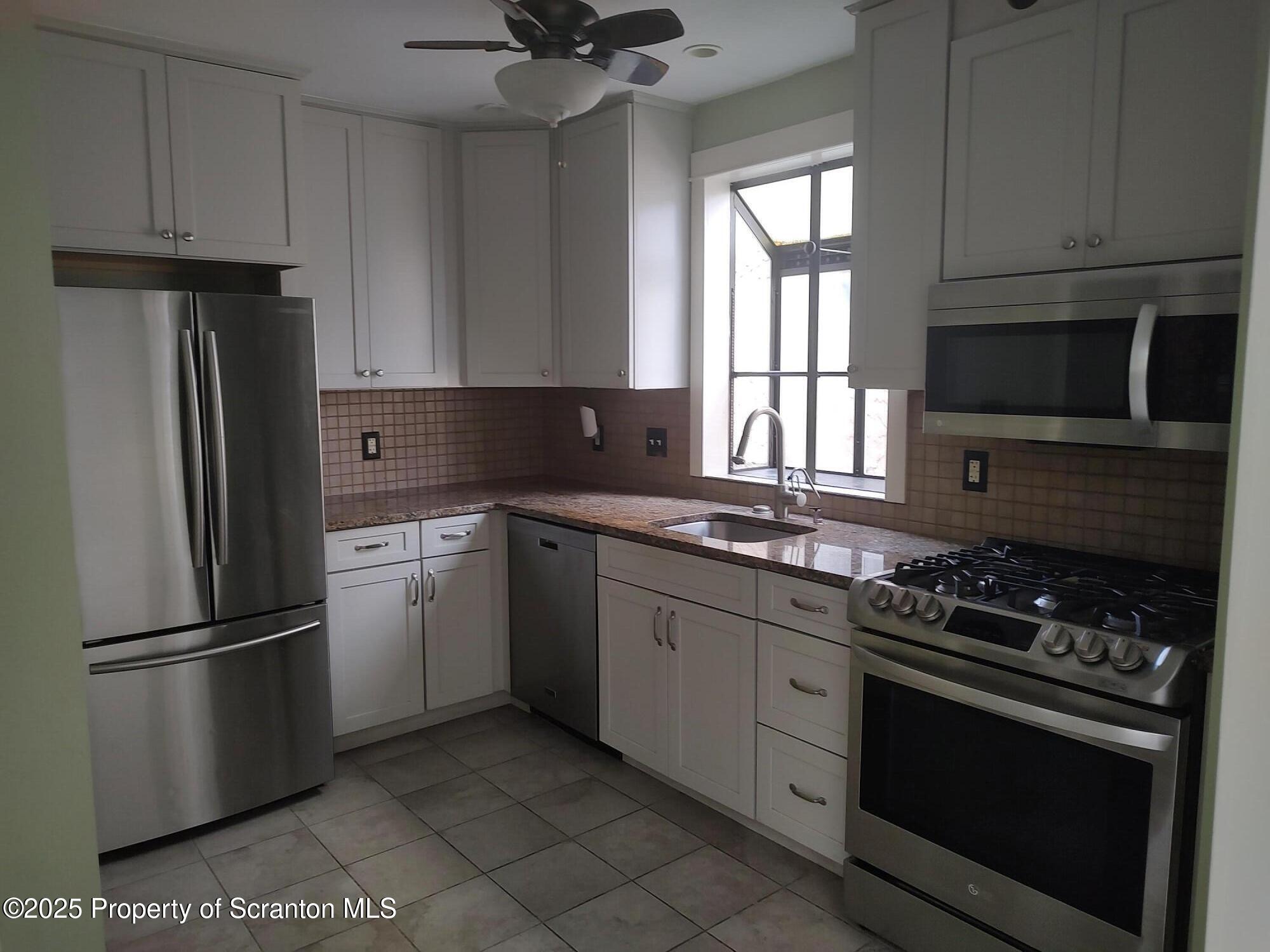 215 West Grove Street Clarks Summit, PA 18411 - Photo 13 of 26 a kitchen with a refrigerator stove and microwave
