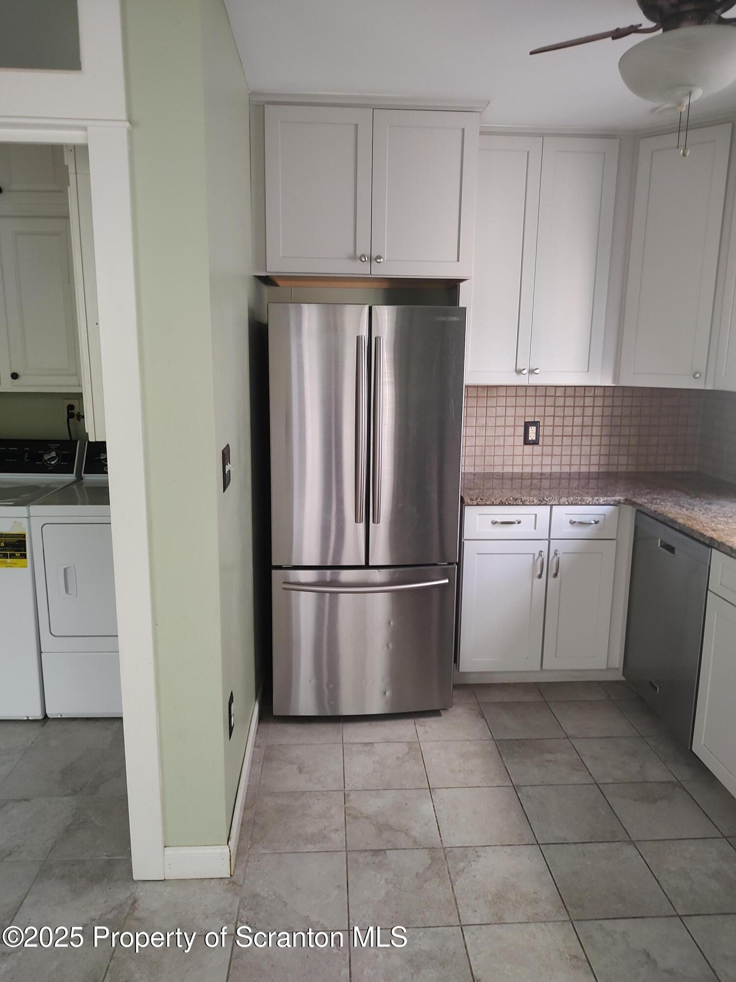 215 West Grove Street Clarks Summit, PA 18411 - Photo 14 of 26 a kitchen with a refrigerator sink and cabinets