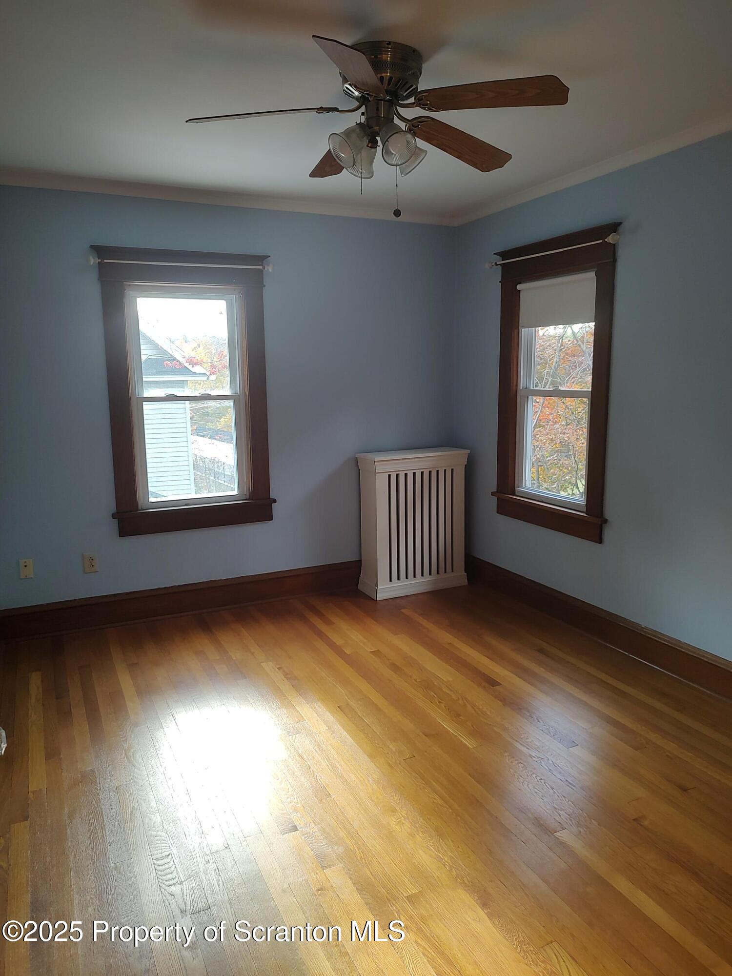215 West Grove Street Clarks Summit, PA 18411 - Photo 23 of 26 a view of an empty room with a window and wooden floor
