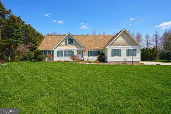 a front view of a house with a yard table and chairs