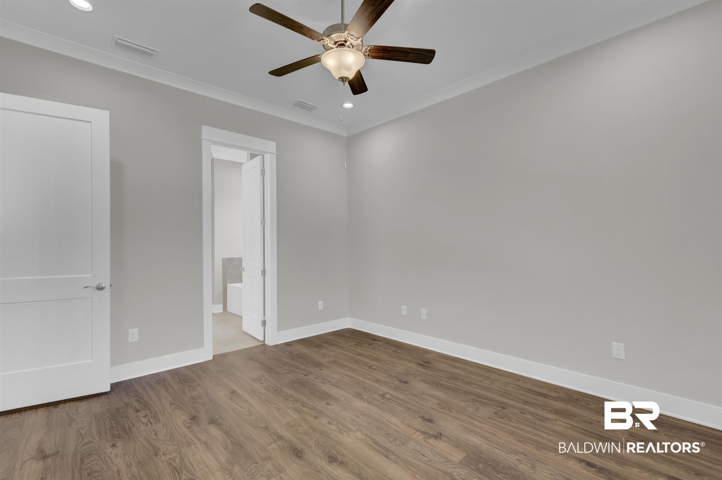 571 Morning Mist Way Fairhope, AL 36532 - Photo 20 of 47 Unfurnished bedroom featuring wood finished floors, a ceiling fan, recessed lighting, ornamental molding, and connected bathroom