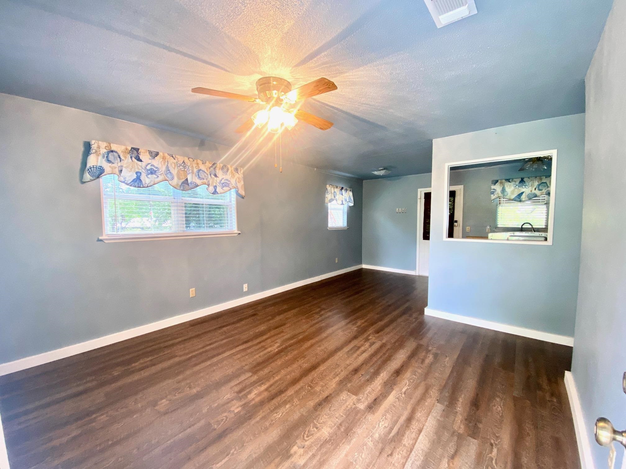 689 Beaver Tow, TX 78672 - Photo 2 of 12 a view of an empty room window and wooden floor