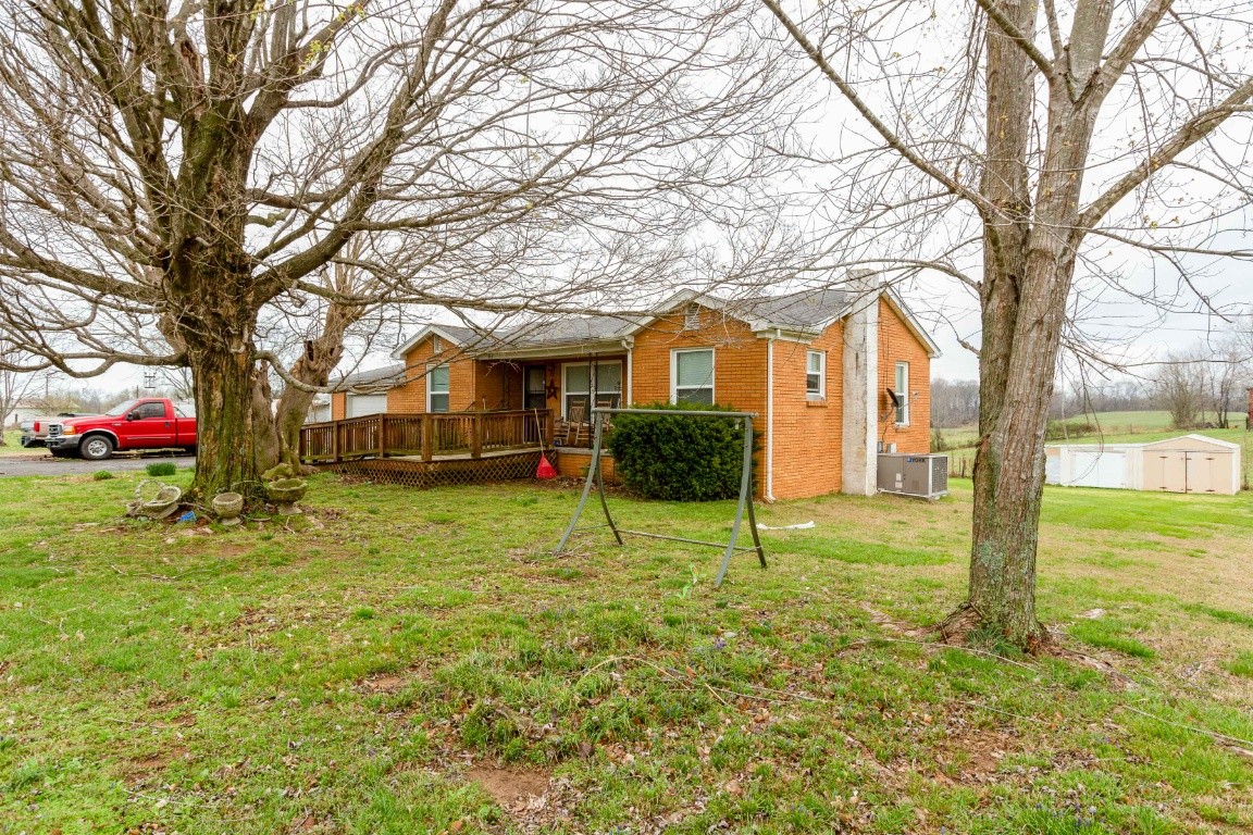416 Keysburg Road Adams, TN 37010 - Photo 2 of 27 a house with trees in the background