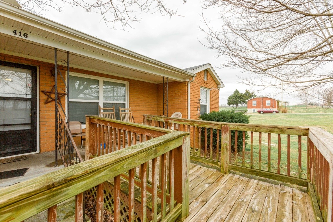 416 Keysburg Road Adams, TN 37010 - Photo 4 of 27 a view of balcony with wooden floor and fence