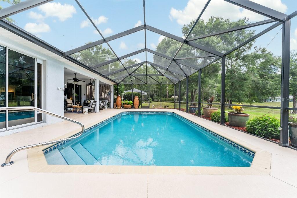 19115 Southwest 98th Loop Dunnellon, FL 34432 - Photo 25 of 36 a view of a swimming pool with a porch