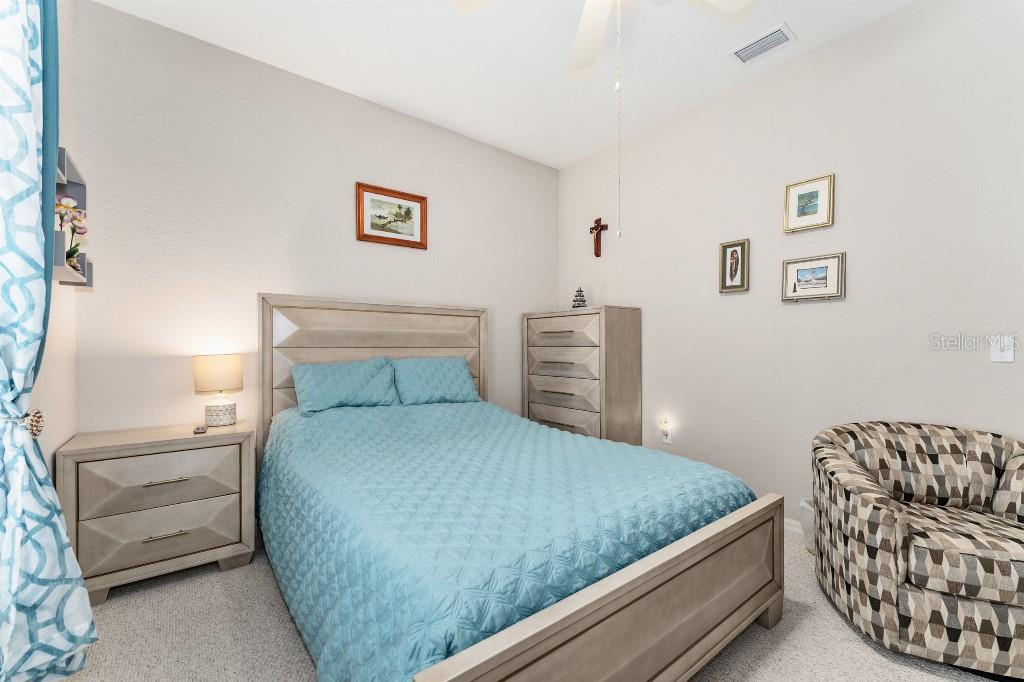 19115 Southwest 98th Loop Dunnellon, FL 34432 - Photo 28 of 36 a bedroom with a bed and couch