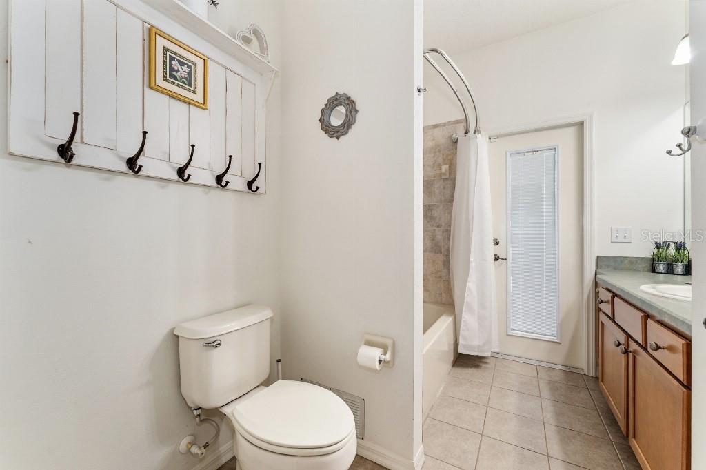 19115 Southwest 98th Loop Dunnellon, FL 34432 - Photo 33 of 36 a bathroom with a toilet a sink a mirror and shower