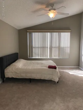 a bedroom with a bed and a night stand