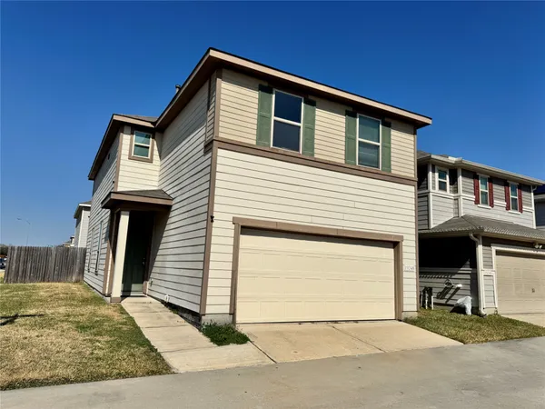 a front view of a house with garage