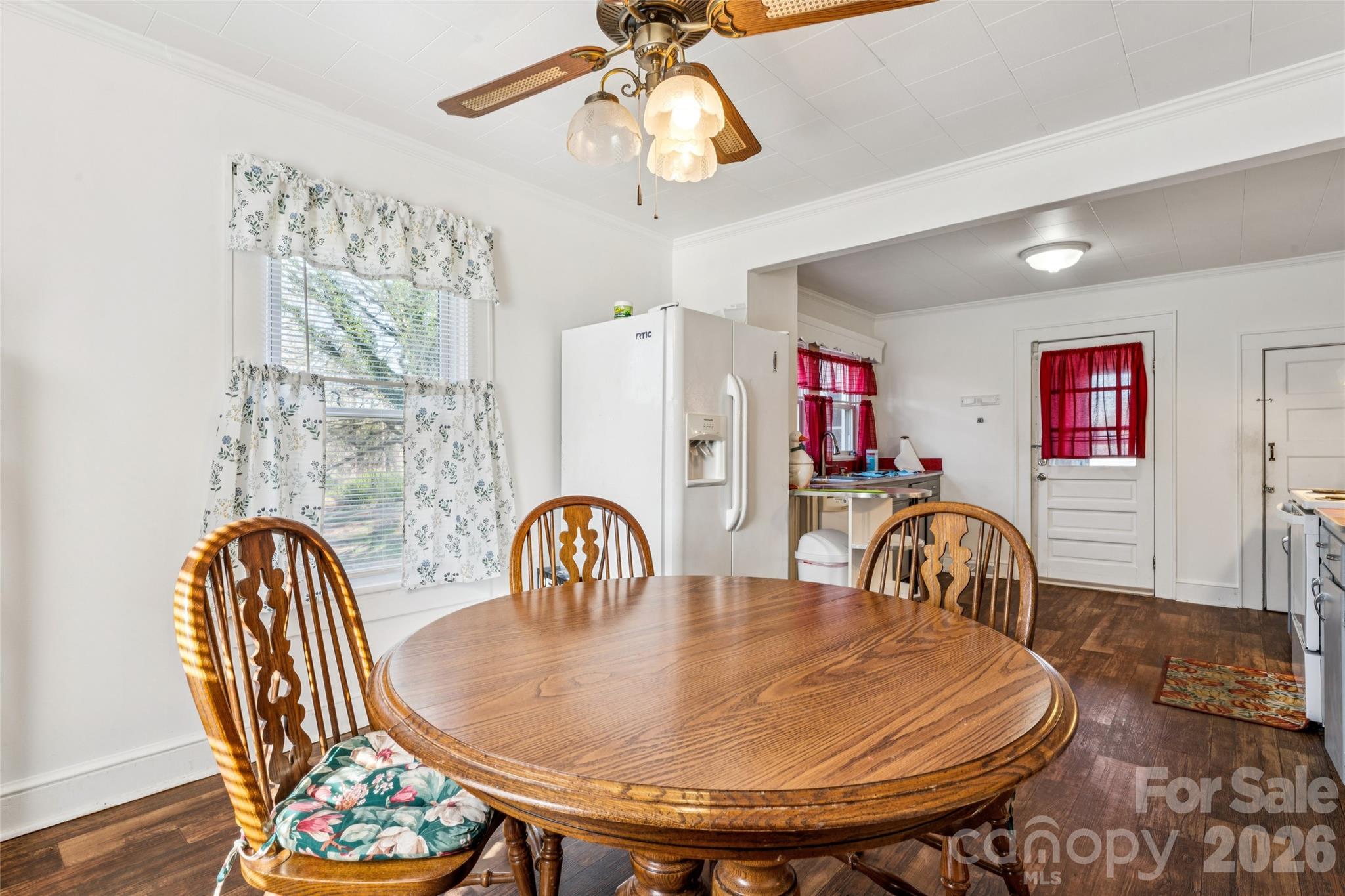 7910 Highway 90 Stony Point, NC 28678 - Photo 13 of 28 a dining room with furniture wooden floor a chandelier
