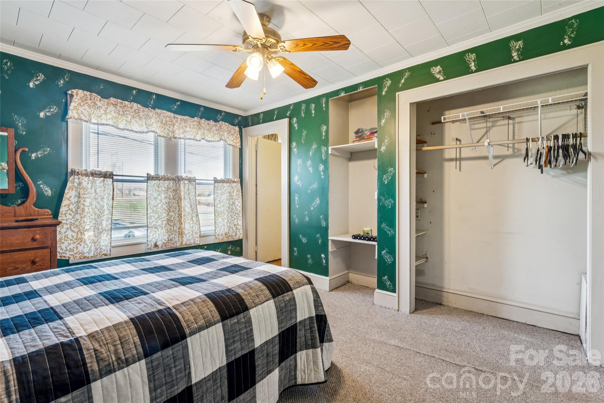 7910 Highway 90 Stony Point, NC 28678 - Photo 16 of 28 a bedroom with a large bed and a chandelier