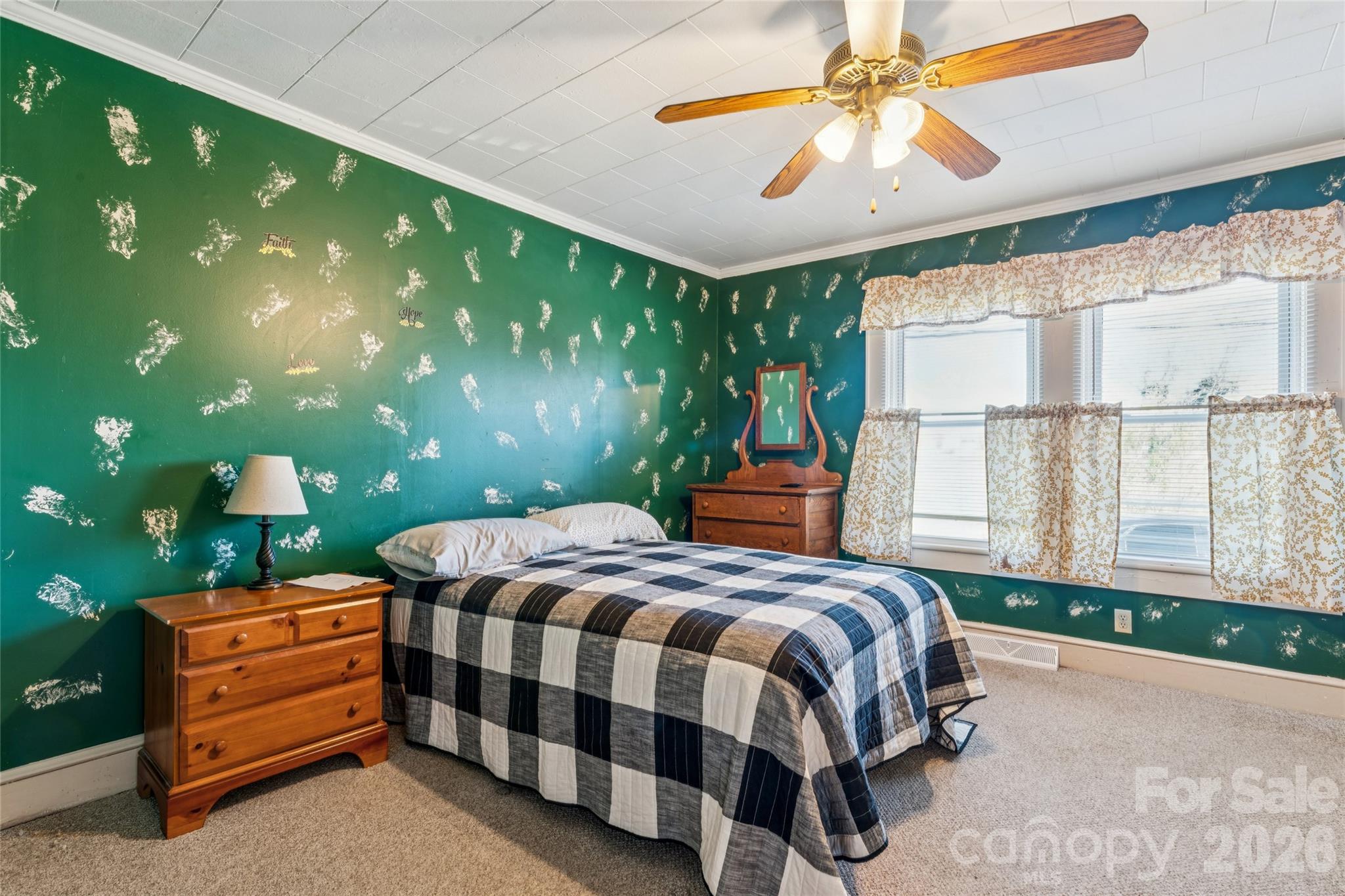 7910 Highway 90 Stony Point, NC 28678 - Photo 19 of 28 a bedroom with a bed and a chandelier