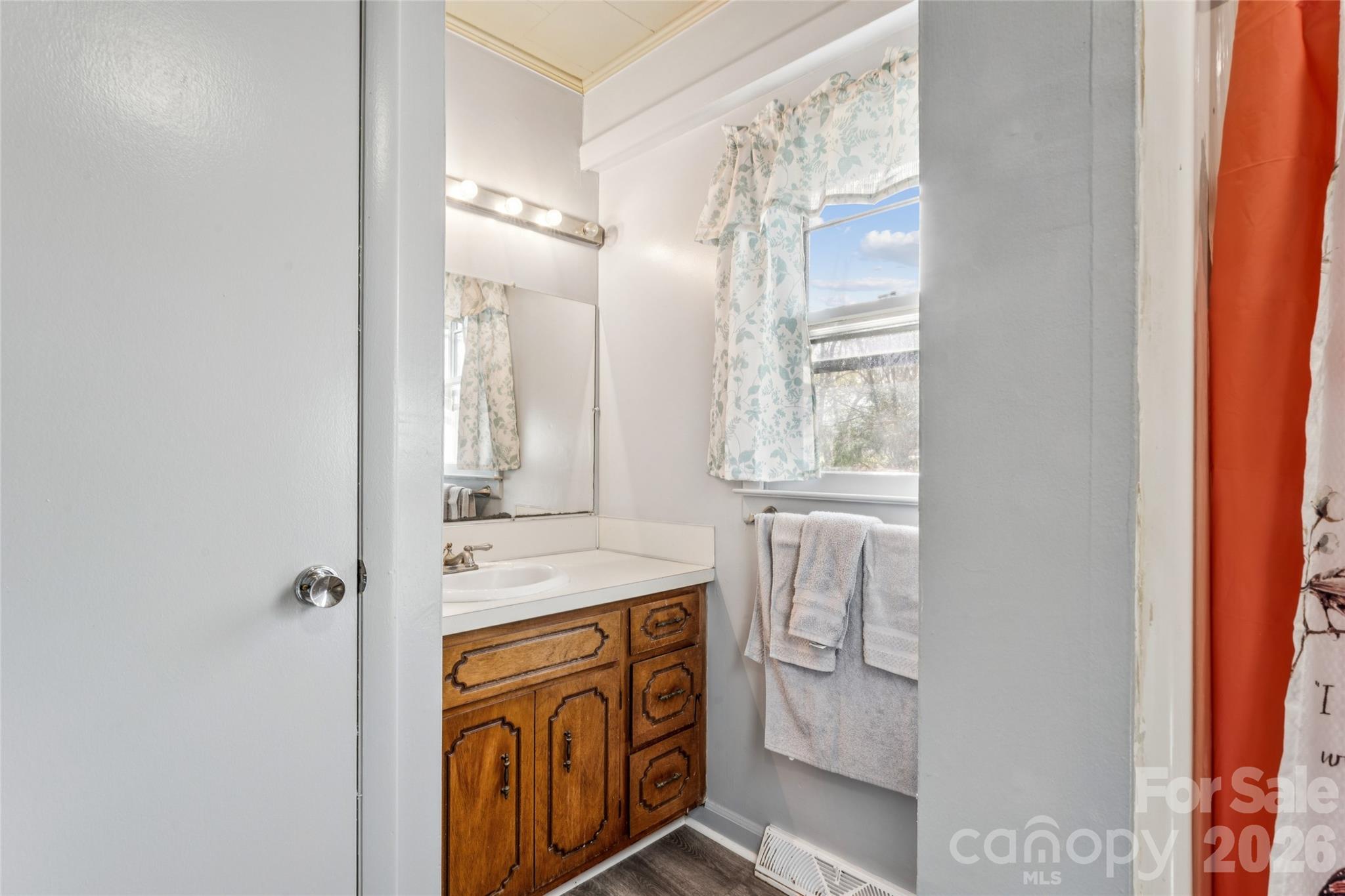 7910 Highway 90 Stony Point, NC 28678 - Photo 23 of 28 a bathroom with a granite countertop sink and a mirror