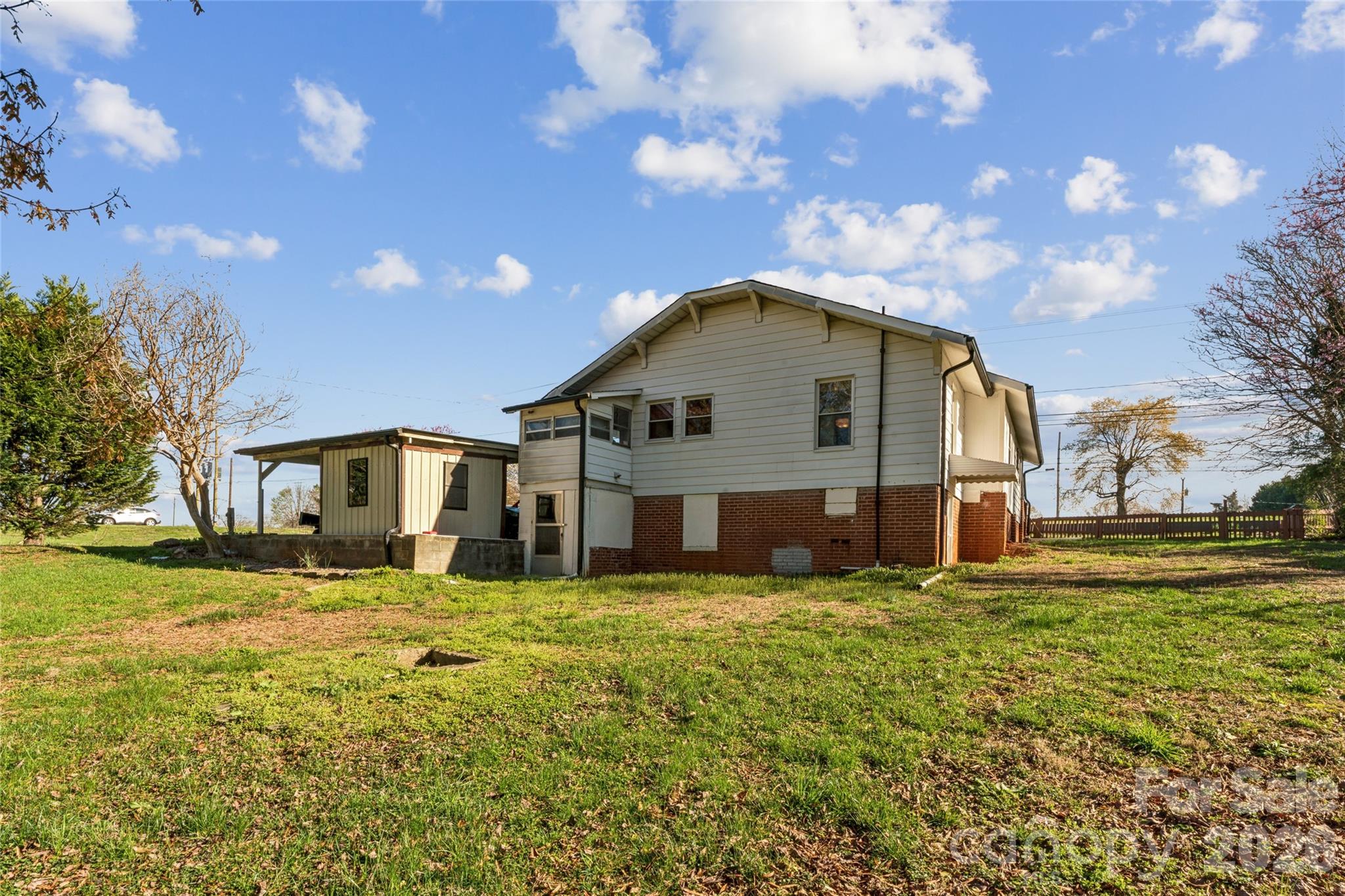 7910 Highway 90 Stony Point, NC 28678 - Photo 26 of 28 a big house with a big yard and large trees
