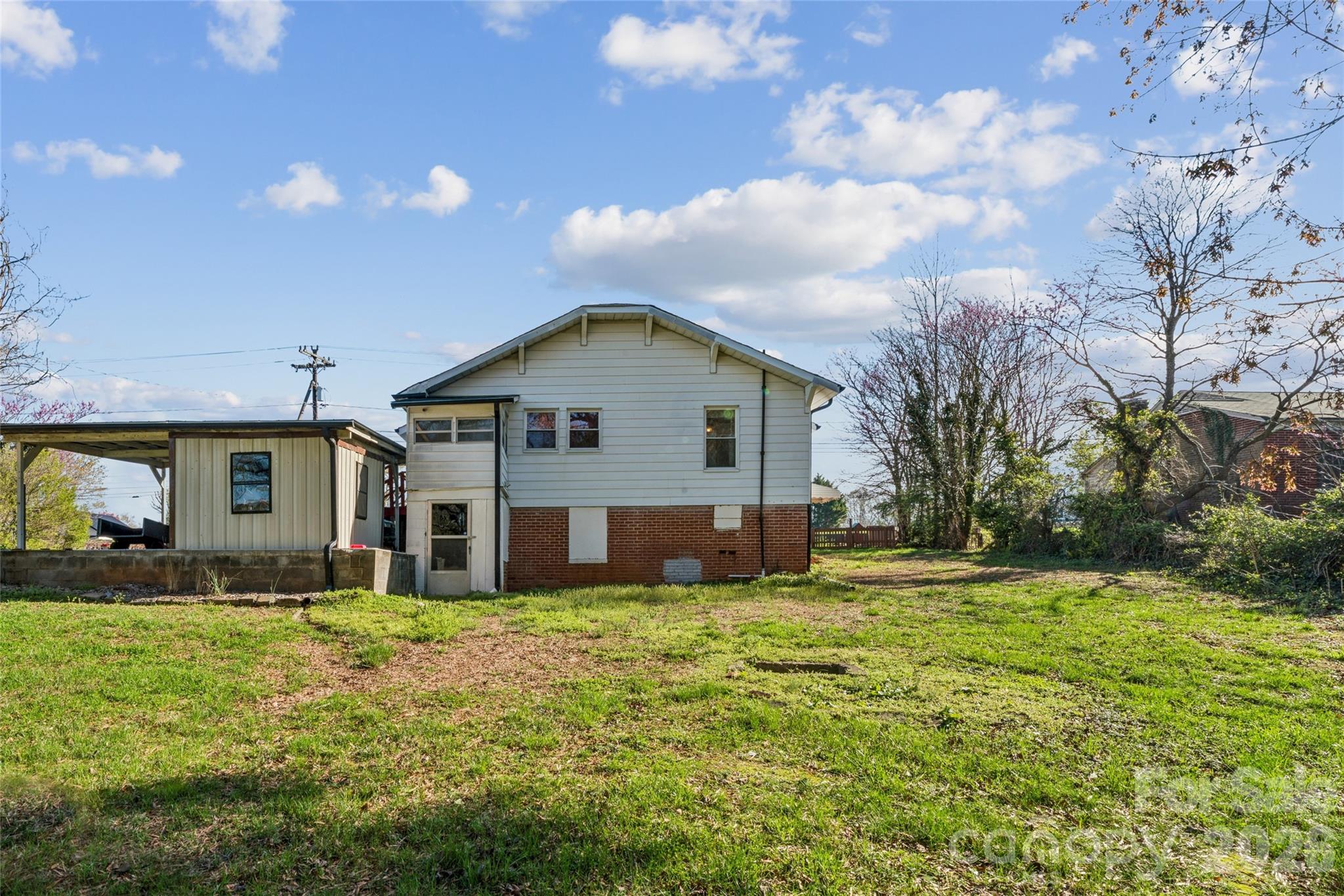 7910 Highway 90 Stony Point, NC 28678 - Photo 27 of 28 a front view of house with yard and trees in the background