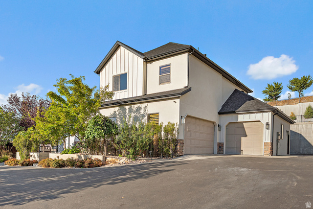 912 North Loafer Canyon Road Elk Ridge, UT 84651 - Photo 7 of 98 Modern exterior with vertical siding and stucco finishes