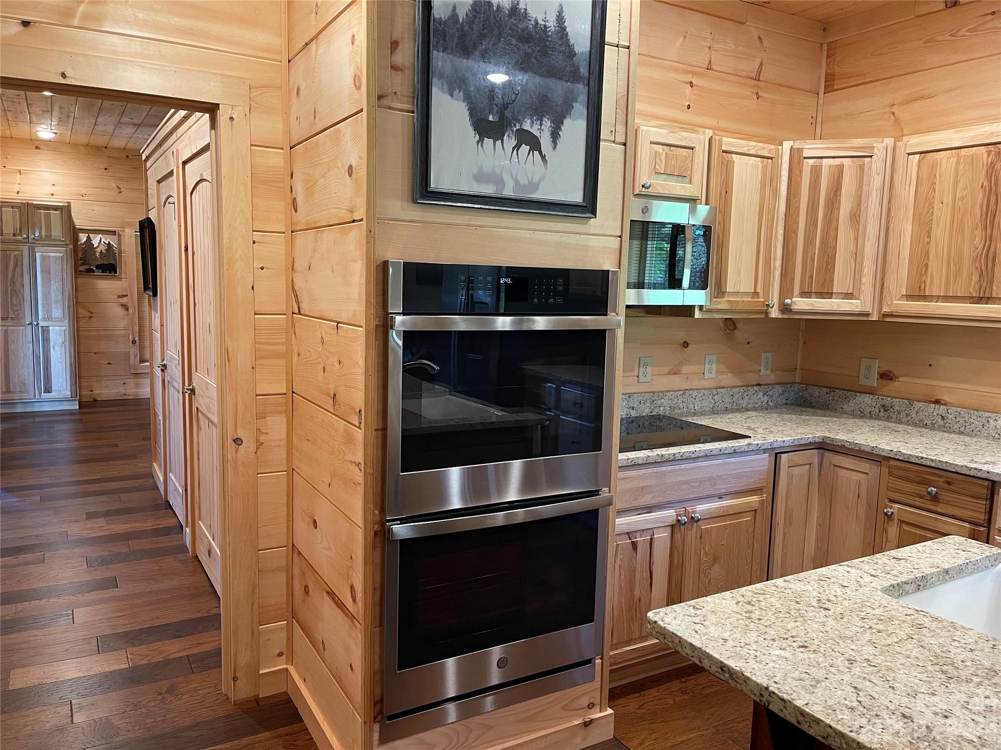 767 Scoggins Road Rutherfordton, NC 28139 - Photo 11 of 27 a kitchen with stainless steel appliances kitchen island wooden cabinets and entryway