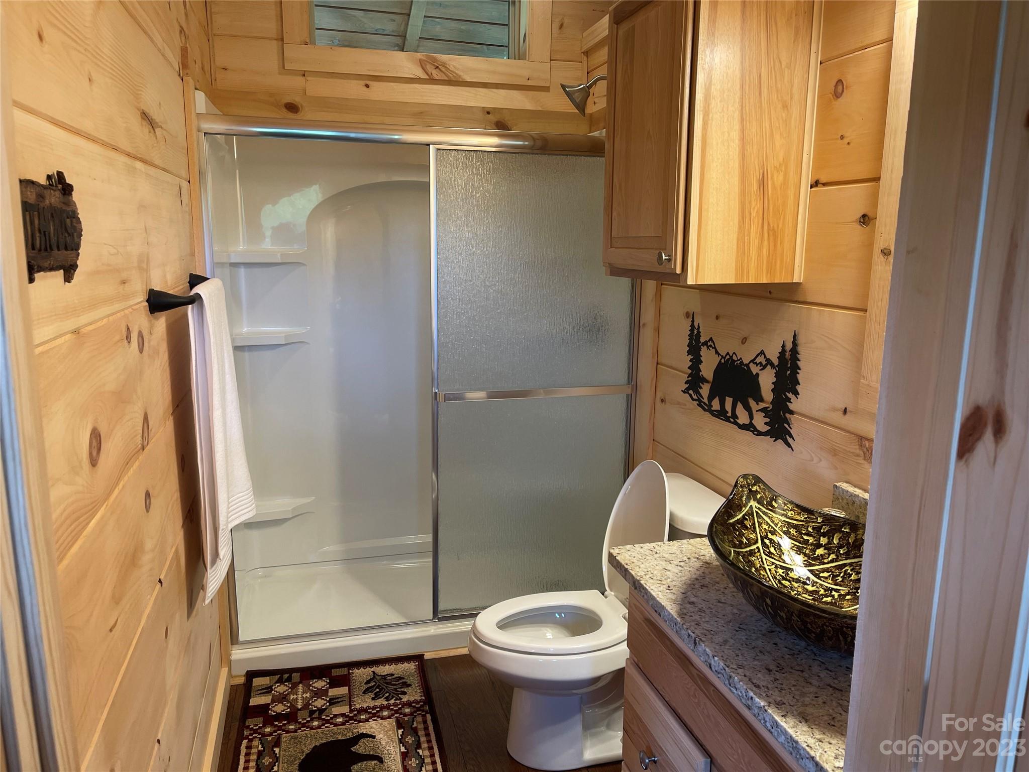 767 Scoggins Road Rutherfordton, NC 28139 - Photo 20 of 27 a bathroom with a granite countertop toilet and a shower