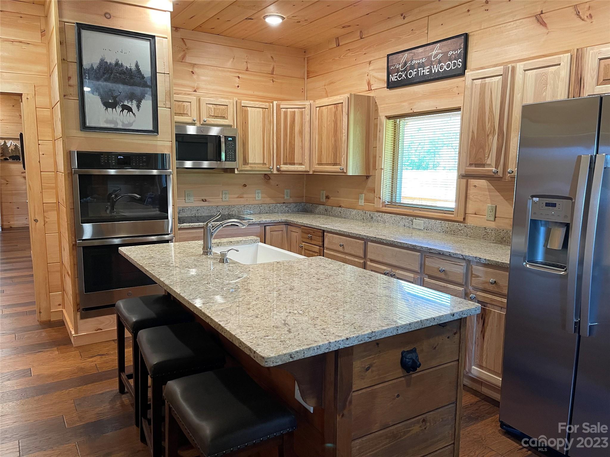 767 Scoggins Road Rutherfordton, NC 28139 - Photo 8 of 27 a kitchen with stainless steel appliances granite countertop a sink stove and refrigerator