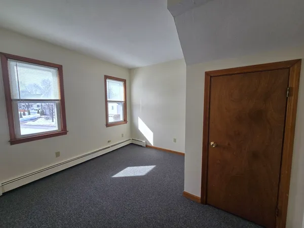 a view of a house with wooden fence
