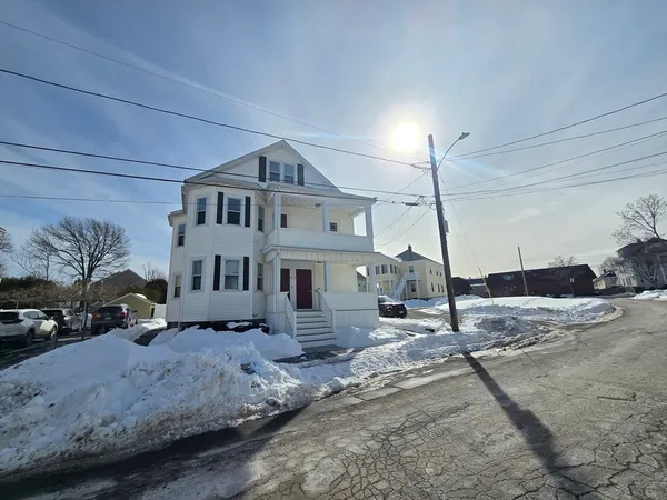 a view of a house with a snow in the yard