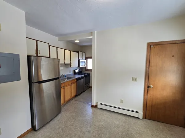 a kitchen with stainless steel appliances a sink a stove and a refrigerator