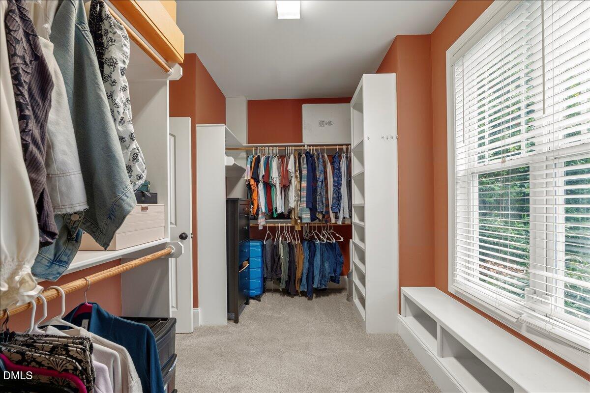 7400 Denlee Road Raleigh, NC 27603 - Photo 23 of 47 a view of walk in closet with clothes and shoes