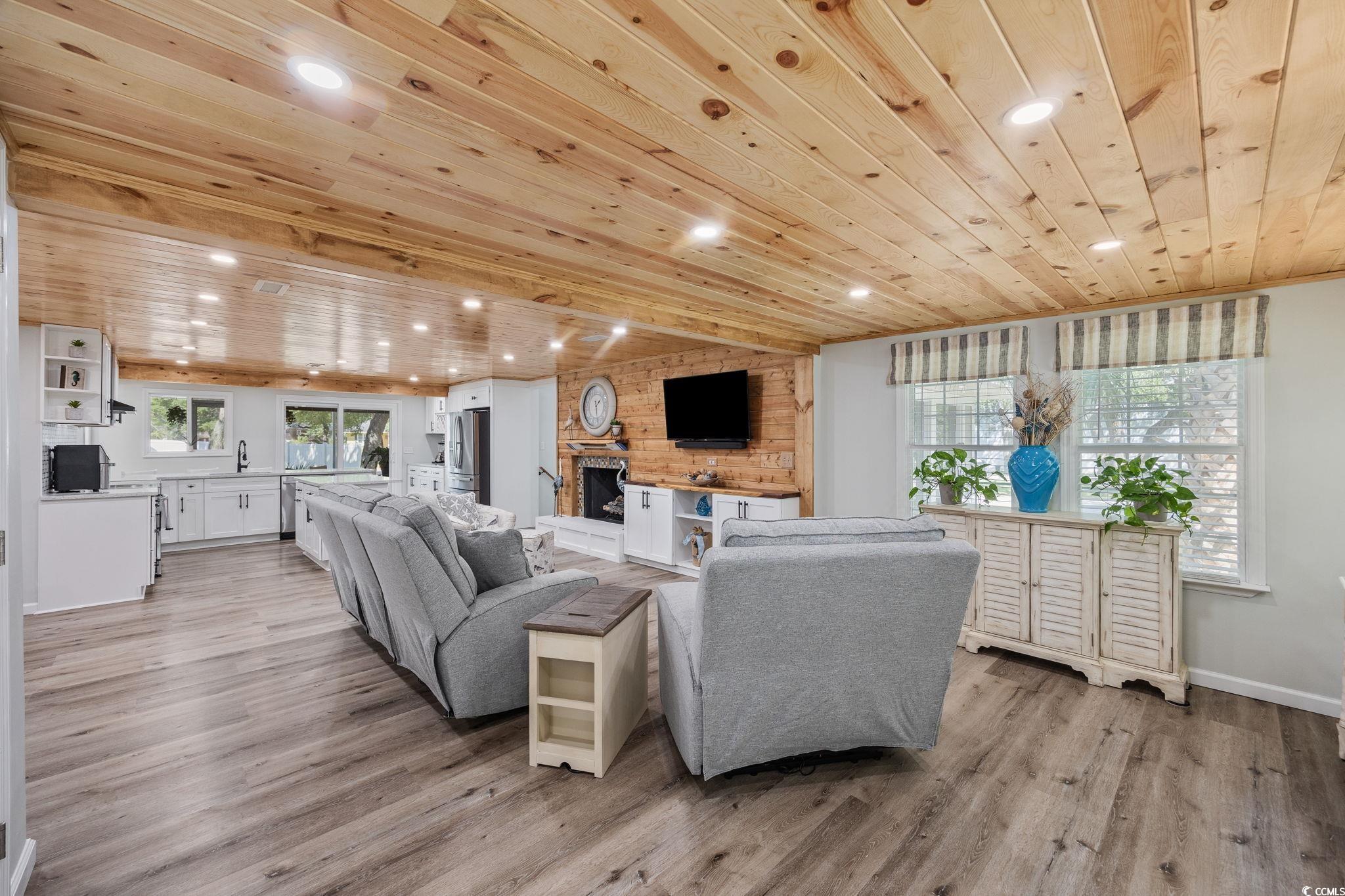 3118 State Rd S-26-816 Murrells Inlet, SC 29576 - Photo 11 of 40 Living area featuring wood ceiling, recessed lighting, light wood-style floors, a fireplace, and wood walls